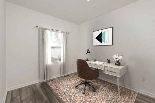 A room with a desk and chair in it.