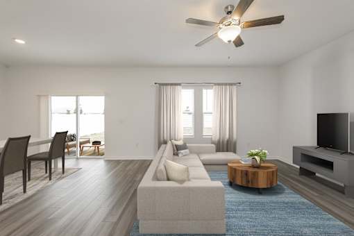 Pet Friendly Homes in Ruskin, FL - Ruskin Reserve - Living Room Area with wood style flooring and a ceiling fan
