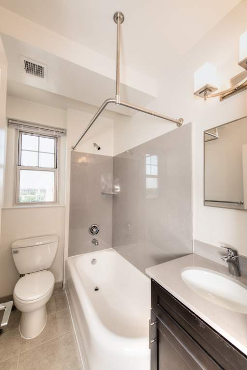 A white toilet is next to a white bathtub in a bathroom.