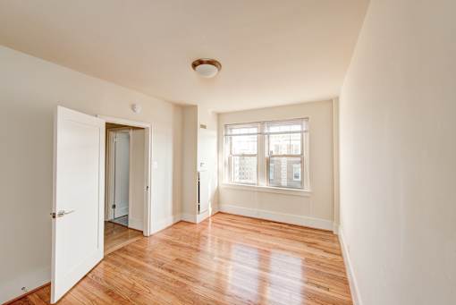 A room with wooden floors and white walls.