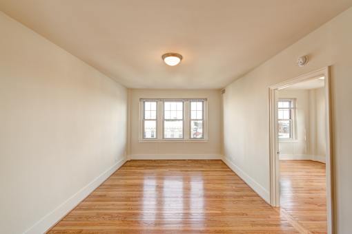 A room with wooden floors and a window.