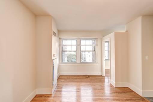 A room with wooden floors and white walls.