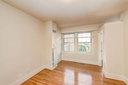 A room with wooden floors and a window.