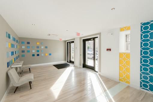 A white chair is in a room with a blue and yellow wall.