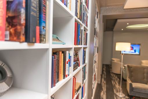 A bookshelf filled with various books in a room.