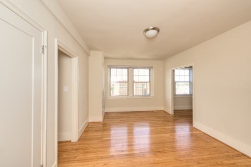 A room with wooden floors and white walls.