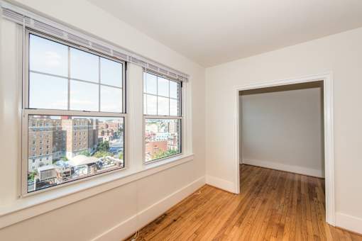 A room with a window overlooking a cityscape.