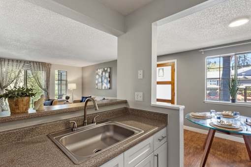 A kitchen with a sink and a window.