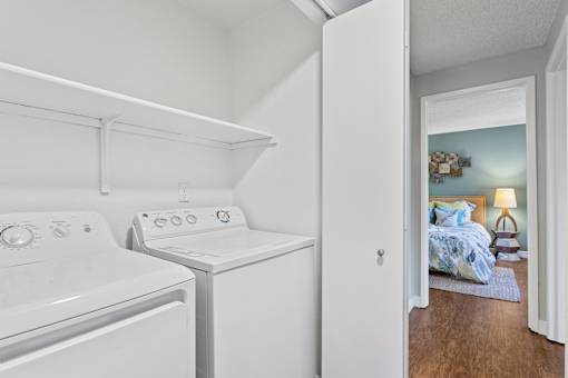 A small laundry room with a washer and dryer.