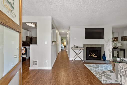 A modern living room with a fireplace and a TV mounted on the wall.