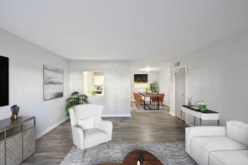 Pet-Friendly Apartments in Sandy Springs– Celebration at Sandy Springs – A living room with a white chair and a brown coffee table.