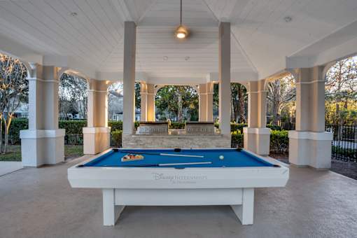 A pool table with Disney Internships written on it.