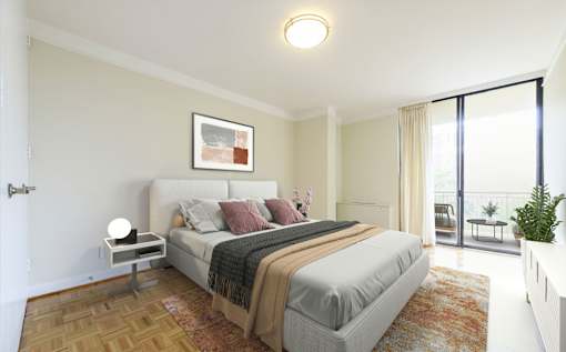 A bedroom with a large bed and a view of the balcony.