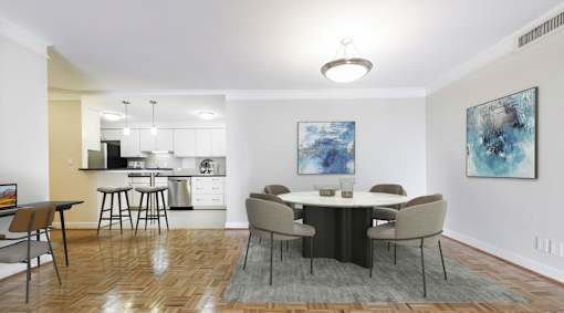 A dining room with a table set for four.