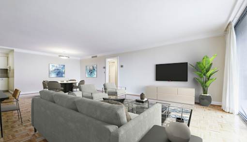 A living room with a grey couch and a black television.
