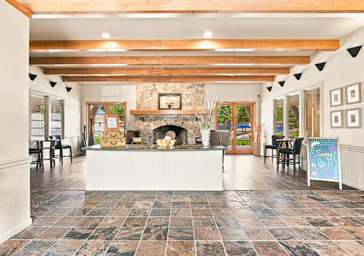 A room with a fireplace and a sign that says "Sunny Days".