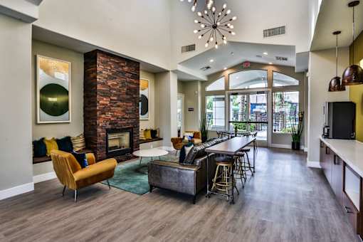 A modern living room with a fireplace and a dining area.