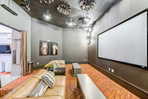 A modern living room with a large couch and a flat screen TV.