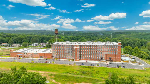 an aerial view of a large brick building surrounded by trees