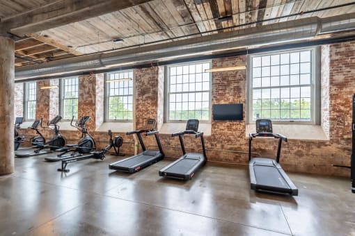 workout equipment in a gym with windows in a loft