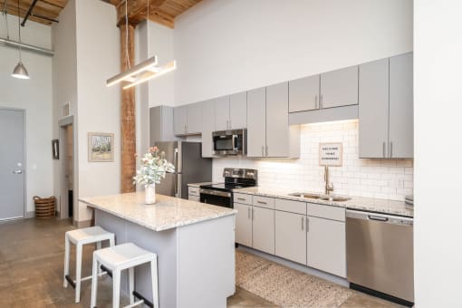 a kitchen with white cabinets and a counter top