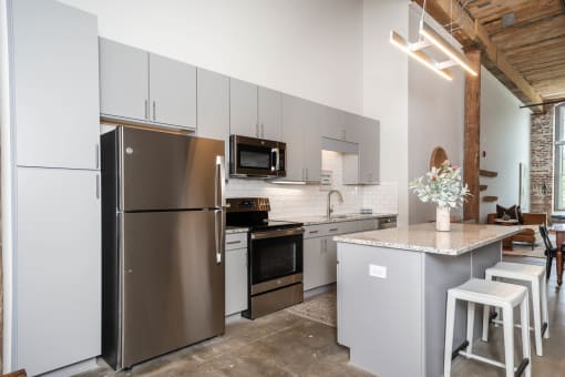 a kitchen with stainless steel appliances and a counter top