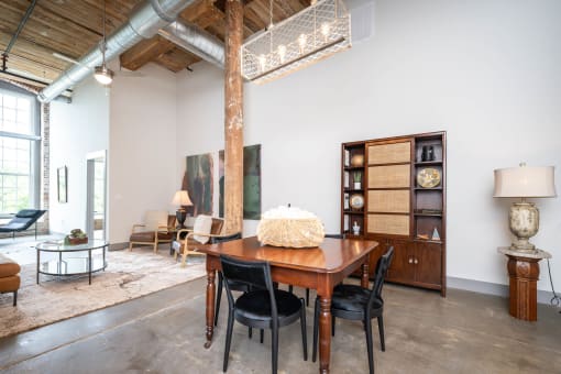 a dining room with a wooden table and black chairs