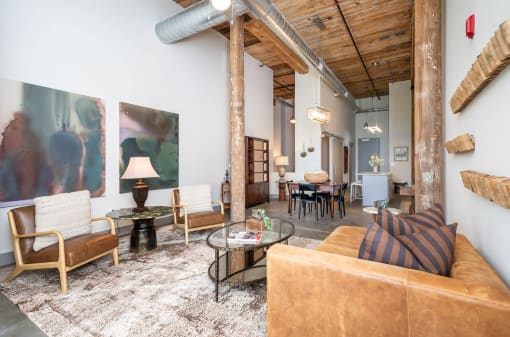 a living room with a couch and chairs and a table