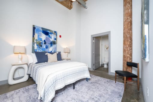 a bedroom with a bed and a bathroom with a toilet