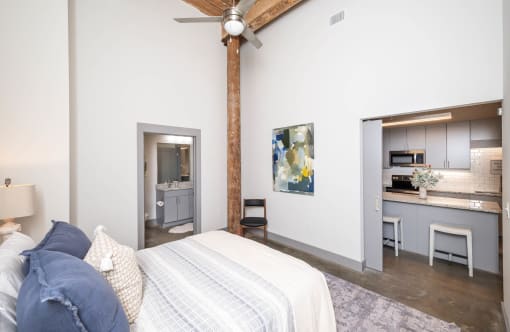 a bedroom with a bed and a ceiling fan