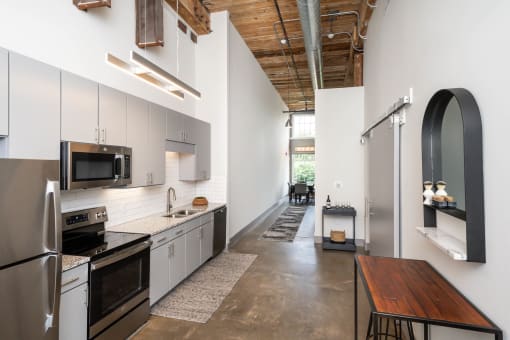 a kitchen with stainless steel appliances and a wooden table