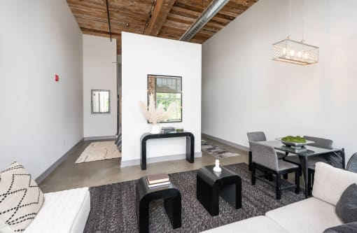 a living room with a couch and chairs and a table