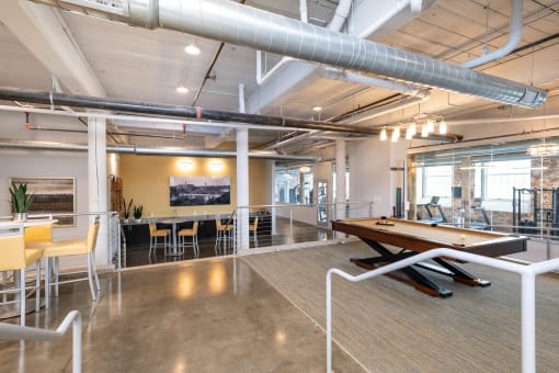 a game room with a pool table and tables