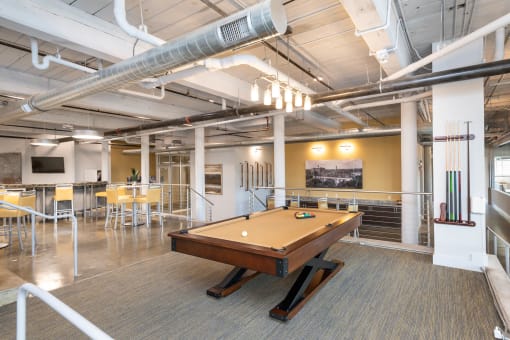 a game room with a pool table and a bar