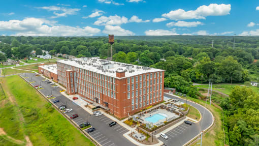 an aerial view of a building and a parking lot