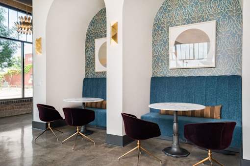 A room with a white table and chairs with gold legs.