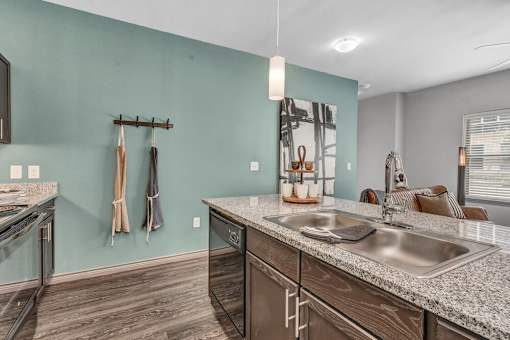 A kitchen with a sink and a counter.