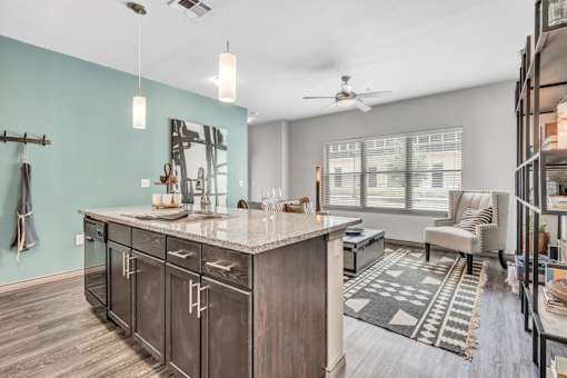 A kitchen with a counter and a fan.