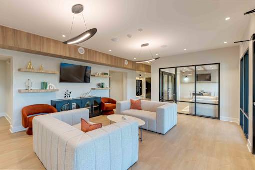 Community lobby with comfortable seating, contemporary lighting, and adjacent office/lounge spaces at Creekline at Fairfield, Fairfield CT.