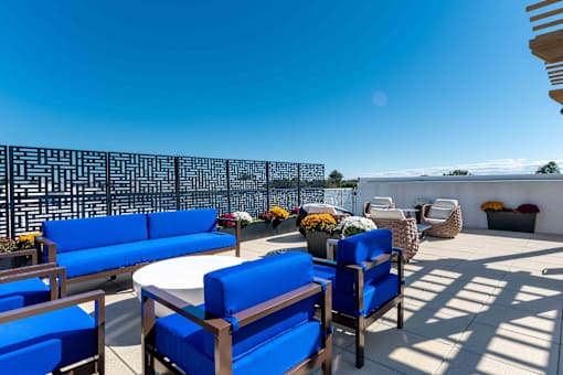 Community rooftop terrace with lounge furniture and skyline views at Creekline at Fairfield apartments, Fairfield CT.