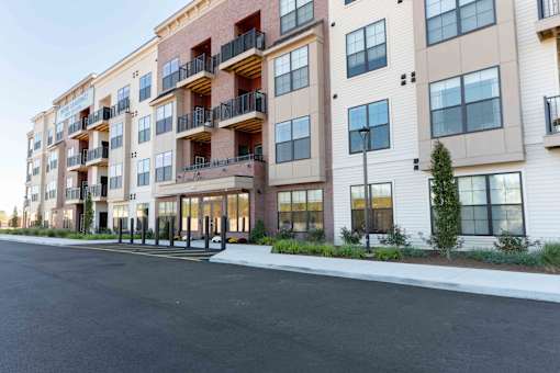 Modern Fairfield, CT apartment building with balconies, large windows, and welcoming front entrance at Creekline at Fairfield.
