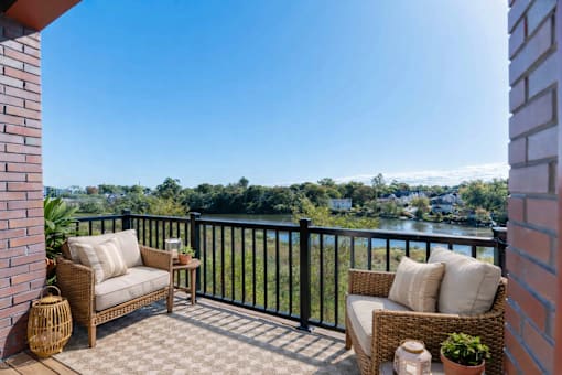 Private balcony at Creekline at Fairfield apartments in Fairfield, CT with scenic riverside views.