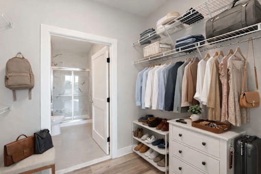 Walk-in closet with shelving leading into an en-suite bathroom at Creekline at Fairfield in Fairfield, Connecticut.