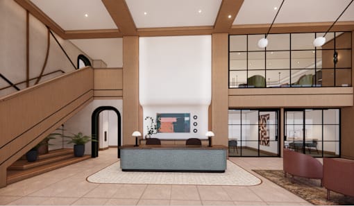A modern living room with a staircase on the left and a sofa set in the center.