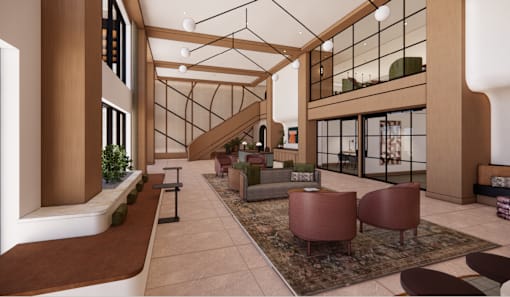 A modern living room with a staircase and a glass wall.