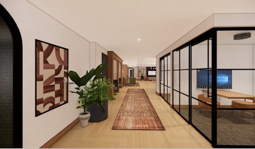 A long hallway with a rug and potted plants on either side.