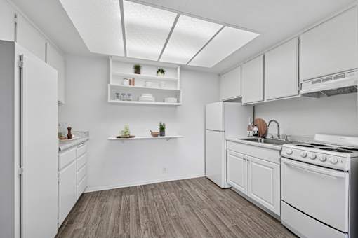 Bright bathroom with tub and white finishes at Sunnyside Senior Apartments