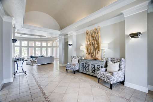 A living room with a grey sofa and a large window.