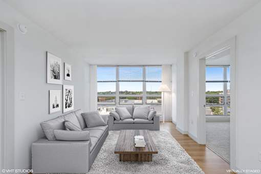 A living room with a grey couch and a coffee table.