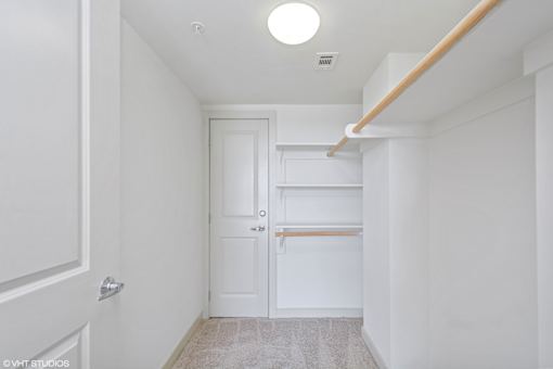 A white door is in a hallway with a light on the ceiling.